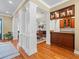 Custom wet bar with wood cabinets, granite countertop and glass shelving at 17120 Boy Scout Rd, Odessa, FL 33556