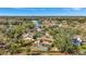 An aerial view of the house including a backyard pool, wooden fence, and solar panels at 1803 Tawnee Pl, Brandon, FL 33510