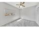 Bright bedroom featuring neutral carpet, a ceiling fan, and a window at 1803 Tawnee Pl, Brandon, FL 33510