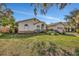 Tan house with arched windows and landscaping at 1803 Tawnee Pl, Brandon, FL 33510