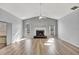 Bright living room with vaulted ceiling, fireplace, and laminate flooring at 1803 Tawnee Pl, Brandon, FL 33510