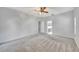 Large main bedroom with plush carpeting and access to bathroom at 1803 Tawnee Pl, Brandon, FL 33510