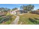 Back of the house with screened in pool, with a walkway made of pavers at 1803 Tawnee Pl, Brandon, FL 33510