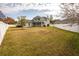 View of the house from the backyard, showing a large grassy area at 18209 Tivoli Ln, Lutz, FL 33558