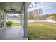 Covered patio with ceiling fan, overlooking a fenced backyard at 18209 Tivoli Ln, Lutz, FL 33558