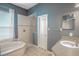 Bathroom with soaking tub, shower, and dual sinks at 18209 Tivoli Ln, Lutz, FL 33558