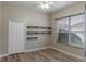 Bedroom with wood-look floors and built-in shelving at 18209 Tivoli Ln, Lutz, FL 33558