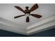 Close-up of ceiling fan with wood blades at 18209 Tivoli Ln, Lutz, FL 33558