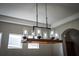 Modern chandelier with wooden accents and glass shades at 18209 Tivoli Ln, Lutz, FL 33558