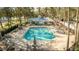 Community pool with lounge chairs and patio at 18209 Tivoli Ln, Lutz, FL 33558