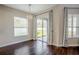 Bright dining room with hardwood floors, sliding glass doors, and a chandelier at 18209 Tivoli Ln, Lutz, FL 33558