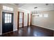 Bright dining room with hardwood floors and a modern chandelier at 18209 Tivoli Ln, Lutz, FL 33558