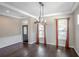 Spacious dining room featuring hardwood floors and an elegant chandelier at 18209 Tivoli Ln, Lutz, FL 33558