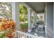 Covered front porch with white columns and a white bench at 18209 Tivoli Ln, Lutz, FL 33558