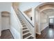 Elegant staircase with dark wood steps and white railings at 18209 Tivoli Ln, Lutz, FL 33558