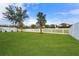 Large backyard with a white fence and green grass at 19231 Pepper Grass Dr, Tampa, FL 33647