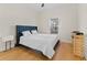 Bright bedroom with hardwood floors and a navy bed at 19231 Pepper Grass Dr, Tampa, FL 33647