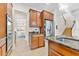 Kitchen with stainless steel appliances and wood cabinets, view to dining room at 19231 Pepper Grass Dr, Tampa, FL 33647