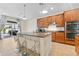 Kitchen with island, stainless steel appliances, and wood cabinets at 19231 Pepper Grass Dr, Tampa, FL 33647