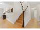 Elegant staircase with hardwood floors and white railings at 19231 Pepper Grass Dr, Tampa, FL 33647