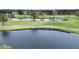 Golf course community with scenic lake and lush landscaping at 1937 Sterling Glen Ct, Sun City Center, FL 33573