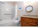 Clean bathroom, shower/tub combo, wood vanity, and granite countertop at 1937 Sterling Glen Ct, Sun City Center, FL 33573