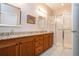 Elegant bathroom with granite double vanity, large shower, and tiled floor at 1937 Sterling Glen Ct, Sun City Center, FL 33573