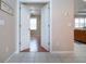 Open doorway reveals a light-filled room with hardwood floors and neutral walls at 1937 Sterling Glen Ct, Sun City Center, FL 33573