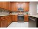 Well-equipped kitchen with wood cabinets and granite counters at 1937 Sterling Glen Ct, Sun City Center, FL 33573