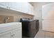 Laundry room with washer, dryer, cabinets, and utility sink at 1937 Sterling Glen Ct, Sun City Center, FL 33573