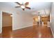 Open living area with hardwood floors and views into kitchen at 1937 Sterling Glen Ct, Sun City Center, FL 33573