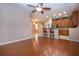 Hardwood floor living room, open to kitchen with breakfast bar at 1937 Sterling Glen Ct, Sun City Center, FL 33573