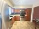 Modern kitchen with stainless steel appliances and wood cabinets at 2284 Spanish Dr # 26, Clearwater, FL 33763