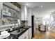 Modern kitchen with stainless steel sink, granite countertops, and dining area view at 2715 14Th N Ave, St Petersburg, FL 33713