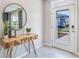 Bright and airy entryway with a console table and large mirror at 2927 Gardiner Ln, Zephyrhills, FL 33541