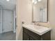 Bathroom with dark vanity, white sink, and large mirror at 2934 3Rd S Ave, St Petersburg, FL 33712