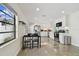 Modern kitchen with white cabinets, stainless steel appliances, and a breakfast table at 2934 3Rd S Ave, St Petersburg, FL 33712