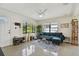 Living room with a green couch, large windows, and concrete floors at 2934 3Rd S Ave, St Petersburg, FL 33712