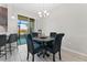 Casual dining area with a round table and black chairs near sliding doors at 29913 Southwell Ln, Wesley Chapel, FL 33543