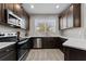 Modern kitchen with dark cabinetry and quartz counters at 29913 Southwell Ln, Wesley Chapel, FL 33543