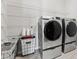 Laundry room with washer, dryer, and ample shelving at 29913 Southwell Ln, Wesley Chapel, FL 33543