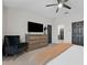 Main bedroom with a dresser and seating area, plus a view of the ensuite bathroom at 29913 Southwell Ln, Wesley Chapel, FL 33543