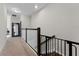 Upstairs hallway with carpeted floors and a safety gate at 29913 Southwell Ln, Wesley Chapel, FL 33543