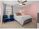 Cozy bedroom with a queen-size bed and two armchairs at 3421 Janna Grace Way, Land O Lakes, FL 34638