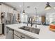 Kitchen island with a farmhouse sink and black faucet at 3421 Janna Grace Way, Land O Lakes, FL 34638