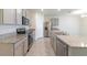 Modern kitchen with stainless steel appliances and granite countertops at 34219 Sorrel Mint Dr, Wesley Chapel, FL 33543