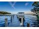 Scenic boat dock on the lake with pontoon boat at 3584 Oak Lake Dr, Palm Harbor, FL 34684