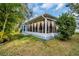 House exterior showcasing a screened patio and well-maintained lawn at 3584 Oak Lake Dr, Palm Harbor, FL 34684