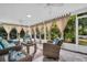 Relaxing screened porch with wicker furniture and view of lush greenery at 3584 Oak Lake Dr, Palm Harbor, FL 34684