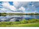 Serene lake view with lush greenery and blue skies at 36750 Us Highway 19 N # 04221, Palm Harbor, FL 34684